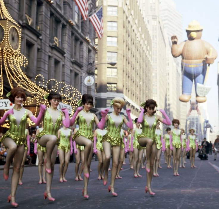 Pink and green and beehives—and some tap-inspired choreography—for the parade in 1966, at which the Rockettes appear to have been the opener for Smoky the Bear (back right).