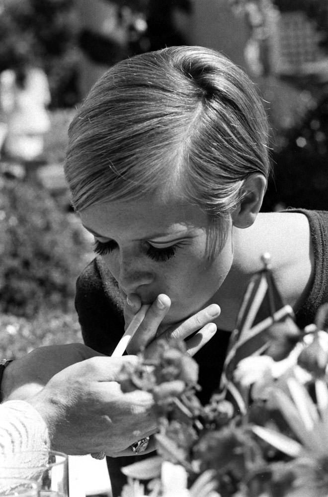 Twiggy lights up at a party thrown for her in Beverly Hills, 1967.