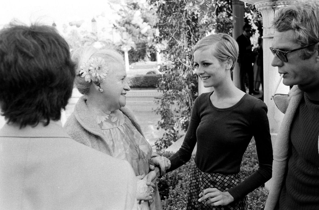 Twiggy (with Steve McQueen, right) and unidentified partygoers in California, 1967.