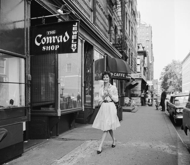 A tourist on a walking tour of New York visits the shops and cafes of Greenwich Village, 1956.