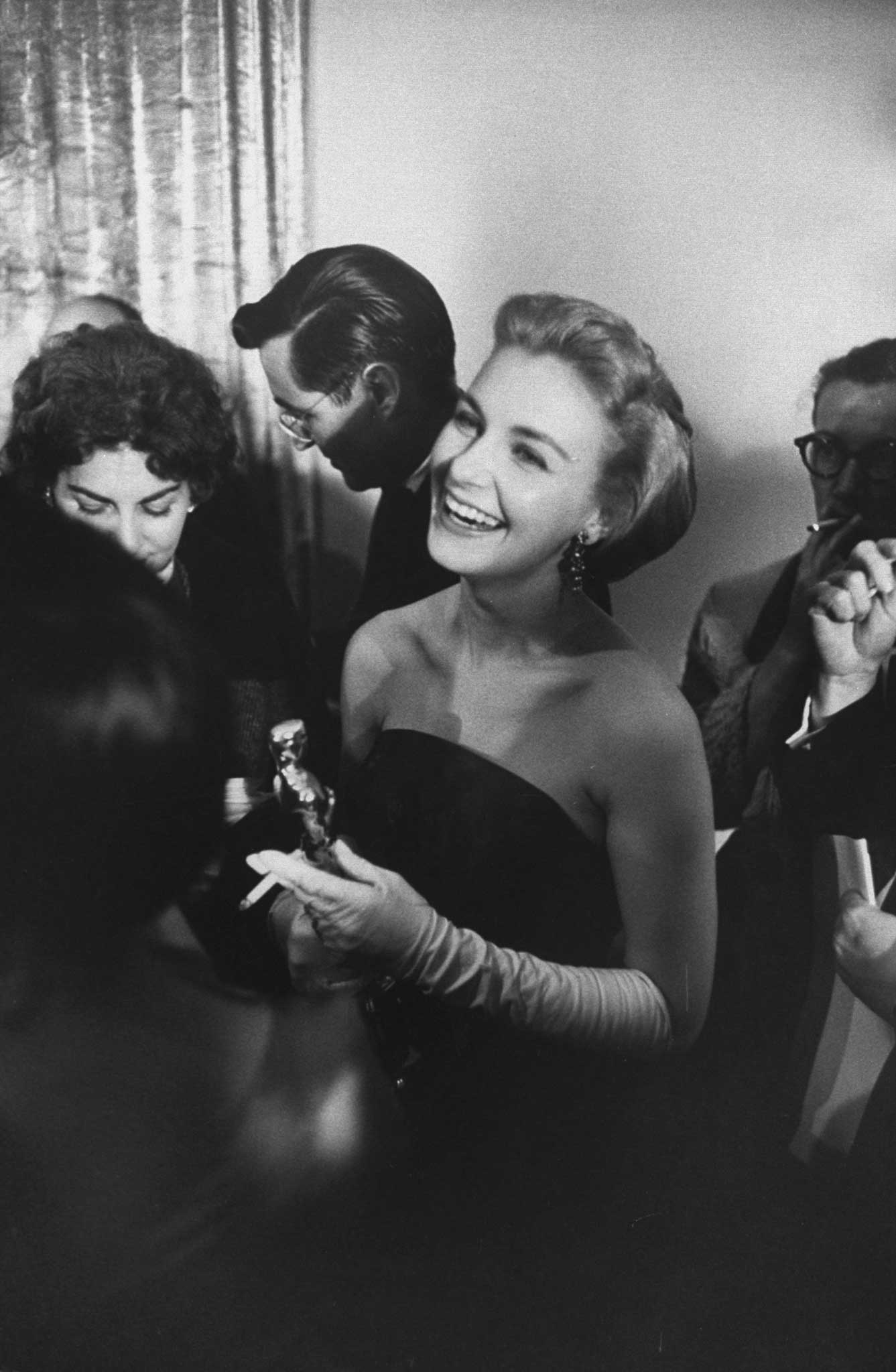 Joanne Woodward smiles radiantly while holding her Best Actress Oscar for her role in Three Faces of Eve, 1958.