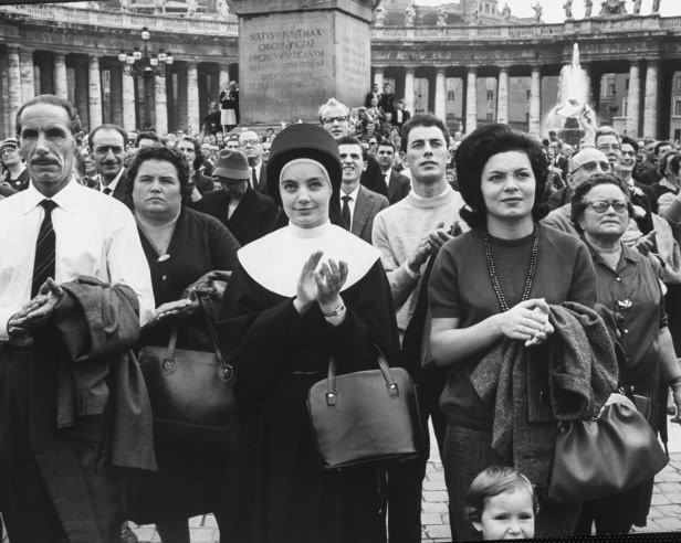 Devout observers of procession of Catholic prelates entering St. Peter's during the Second Vatican Ecumenical Council, 1962