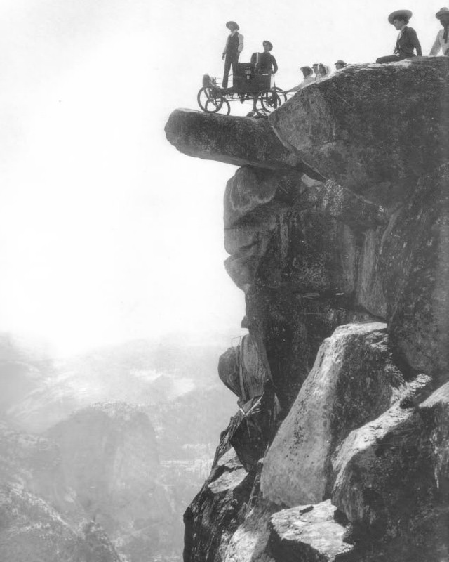 Locomobile steam car on Overhanging Rock in 1900. This was the first automobile to enter Yosemite Valley. Oliver Lippincott drove up the steep, winding road to Glacier Point. The next morning it was hauled onto Overhanging Rock by ropes for this famous photograph.