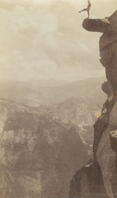 A man poses atop Overhanging Rock at Yosemite National Park’s Glacier Point, circa 1920s.