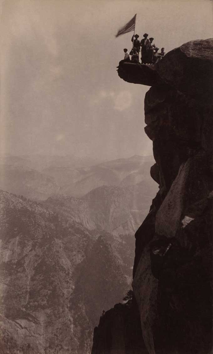 Tourists with an American flag at Glacier Point, Yosemite National Park, 1890’s.