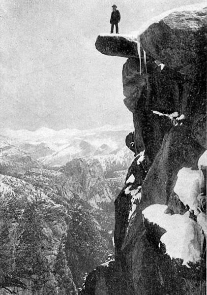 Galen Clark, first guardian of Yosemite Park, standing on Overhanging Rock, Glacier Point.